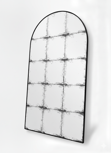 Constantine arch antique mirror at an angle, showing the slim black steel frame and foxed panes