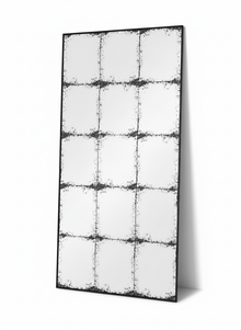 Constantine rectangular antique mirror leaning against a plain white wall