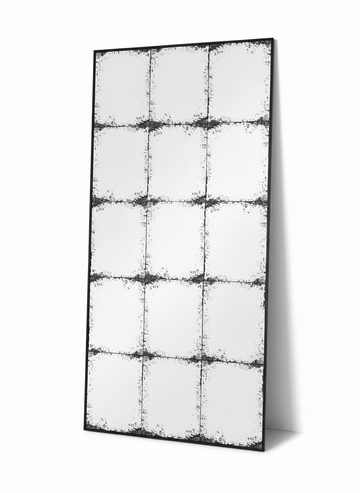 Constantine rectangular antique mirror leaning against a plain white wall
